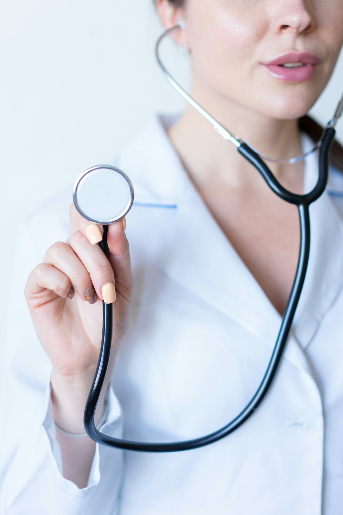 Healthcare provider holding a stethoscope
